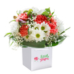 This joyful bouquet, crafted with heartfelt attention by Florist Parsons Green, captures the uplifting mood of springtime in SW6. Thoughtfully arranged within a pristine, square white gift bag, the display combines the tactile pleasure of ruffled coral and peach carnations with the serene brightness of white daisies, each one glowing with a cheerful yellow-green center. Wispy sprays of pure white baby's breath drift throughout the design, softening its outline and lending the arrangement a gentle, dreamy character-like the drifting clouds over Parsons Green on a sunlit afternoon. Nestled alongside are understated buds tinged with purple, promising flourish and transformation as the days pass. Deep, glossy foliage gently cradles the vibrant florals, enveloping them in a natural embrace that echoes the friendly, green avenues around the neighbourhood. The presentation is crisp and modern, with smart ribbon handles signaling a gift meant to be both practical and memorable. Every element in the bouquet reflects skilled local craftsmanship and a sense of occasion, expertly curated to bring happiness whether for a birthday celebration, anniversary, or simply to brighten a day. The arrangement radiates sincerity and delight, embodying the welcoming community spirit that defines Parsons Green, with same-day delivery ensuring every thoughtful gesture arrives fresh and in style.